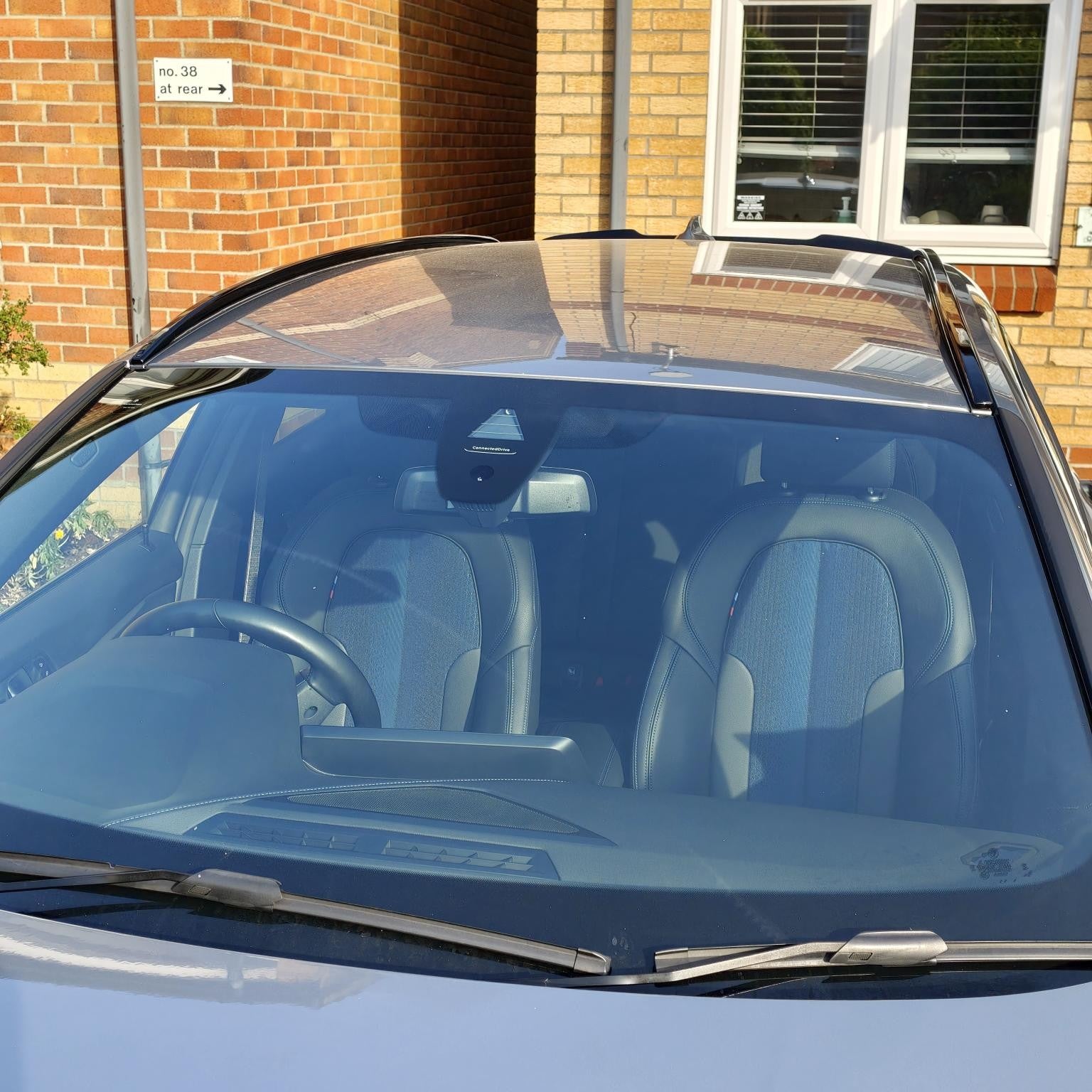 Gloss black exterior luggage rack trims for BMW F40 1 Series (2019-2024), shown on the car's rear exterior.