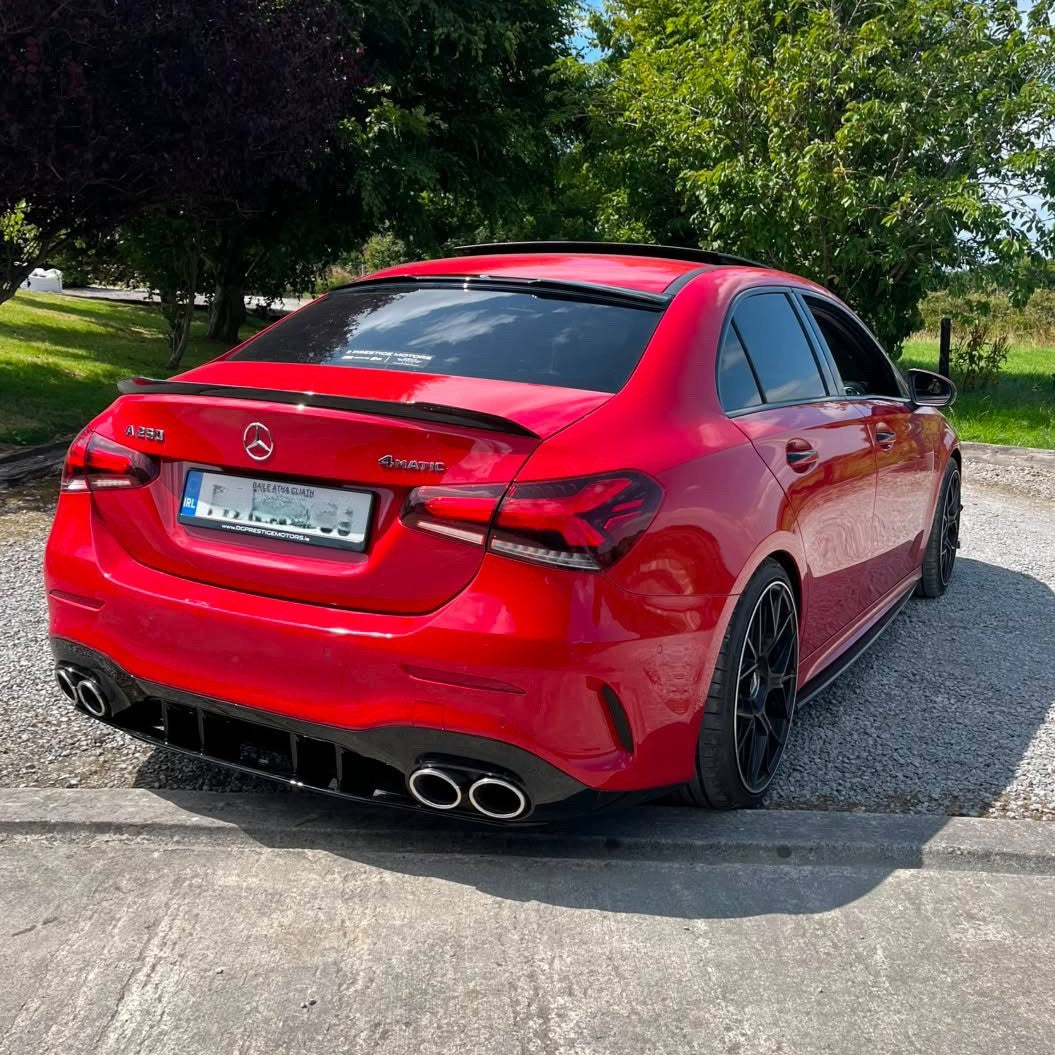 Gloss black A45 style rear diffuser and exhaust tips for Mercedes-Benz W177 A-Class 2018-2025, showcasing sleek design and finishes.