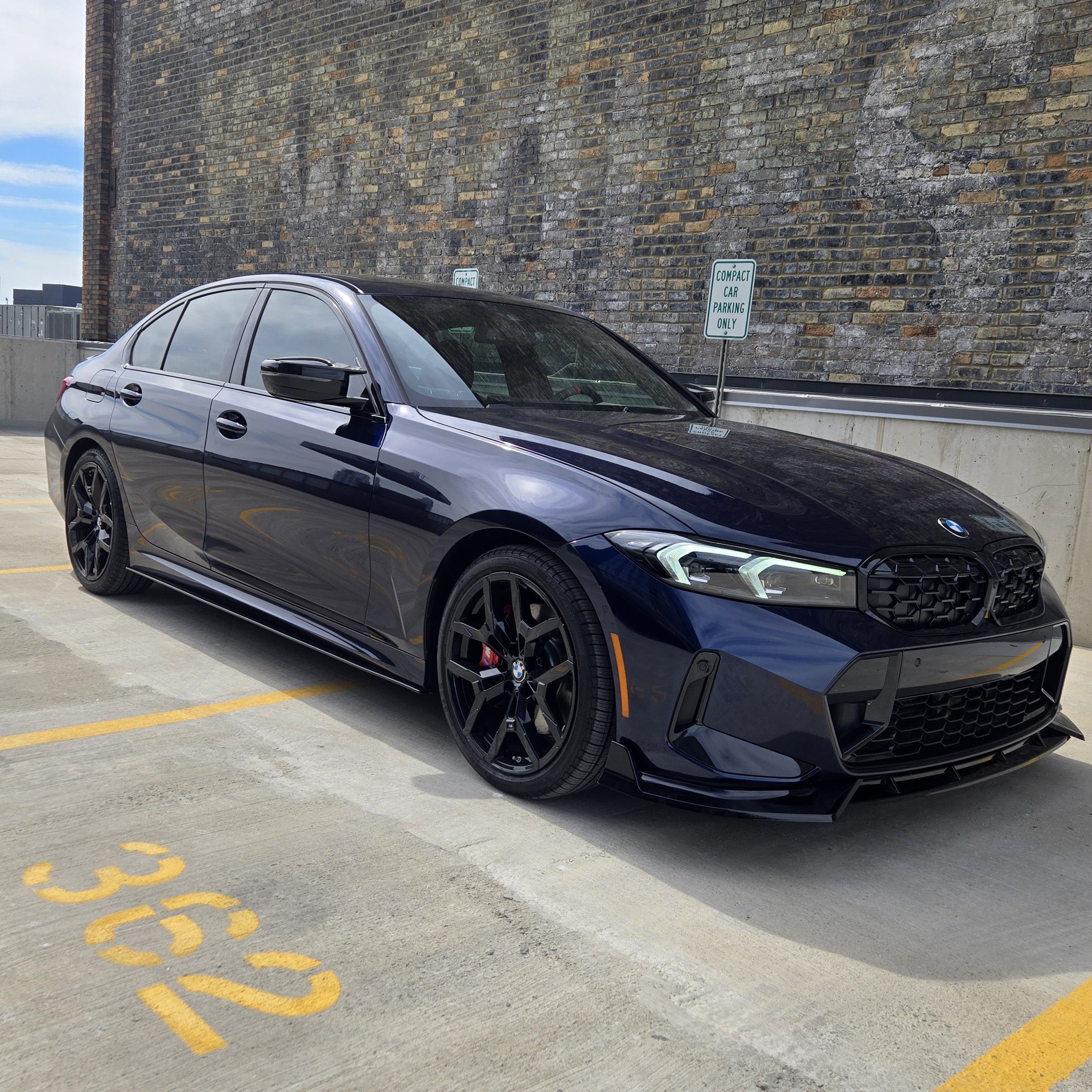 Gloss black front splitter for BMW 3 Series G20 G21 LCI, made by BK Style, designed for sporty aerodynamic enhancement.