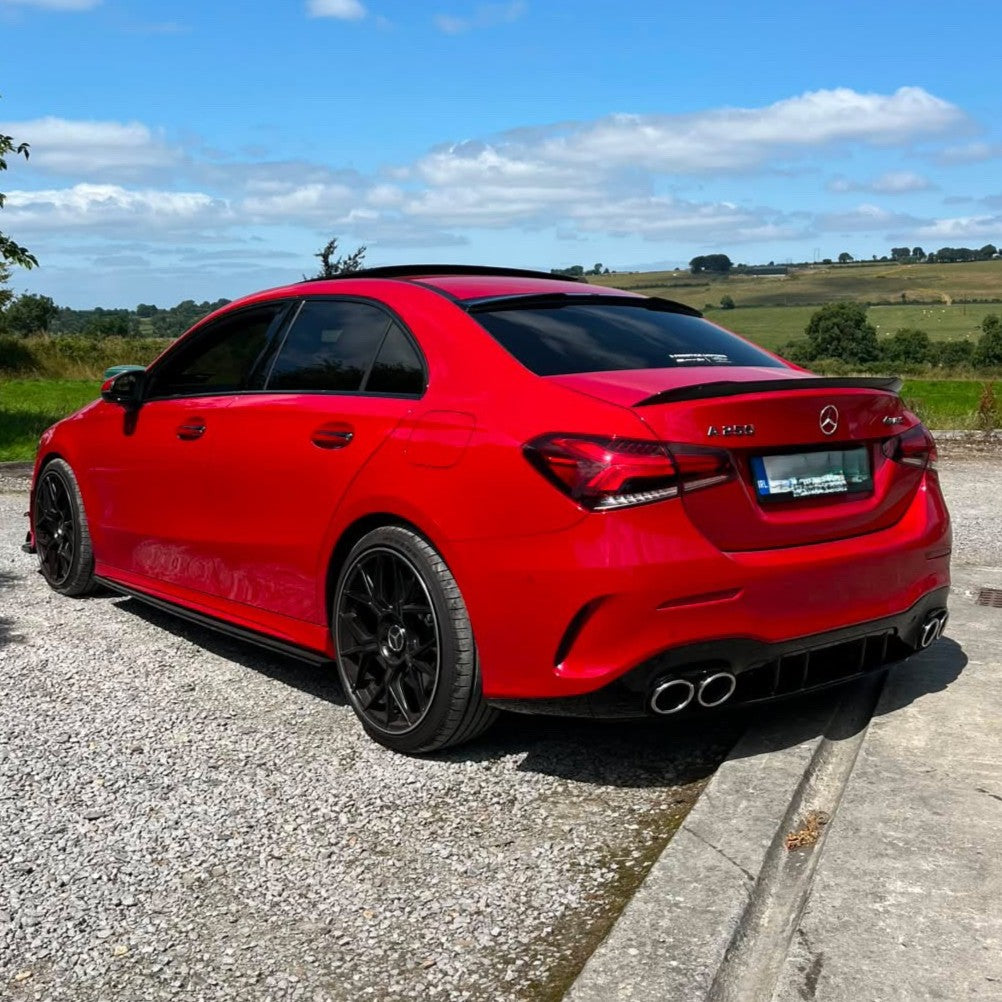 Gloss black A45 style rear diffuser and exhaust tips for Mercedes Benz W177 A Class 2018-2025, showing sleek design and fitment details.