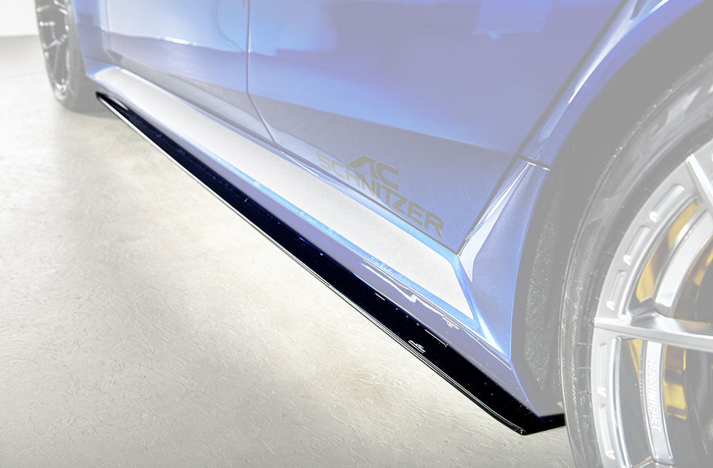 AC Schnitzer side skirts for BMW M5 G90/G99, aerodynamic body kit component, black finish with sporty design details.