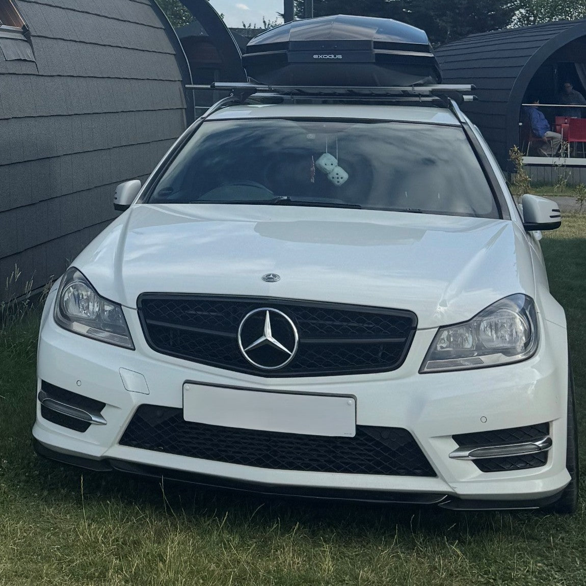 Gloss Black front splitter for Mercedes Benz W204 C Class 2008-2014, showcasing the sleek, aerodynamic design of the splitters.