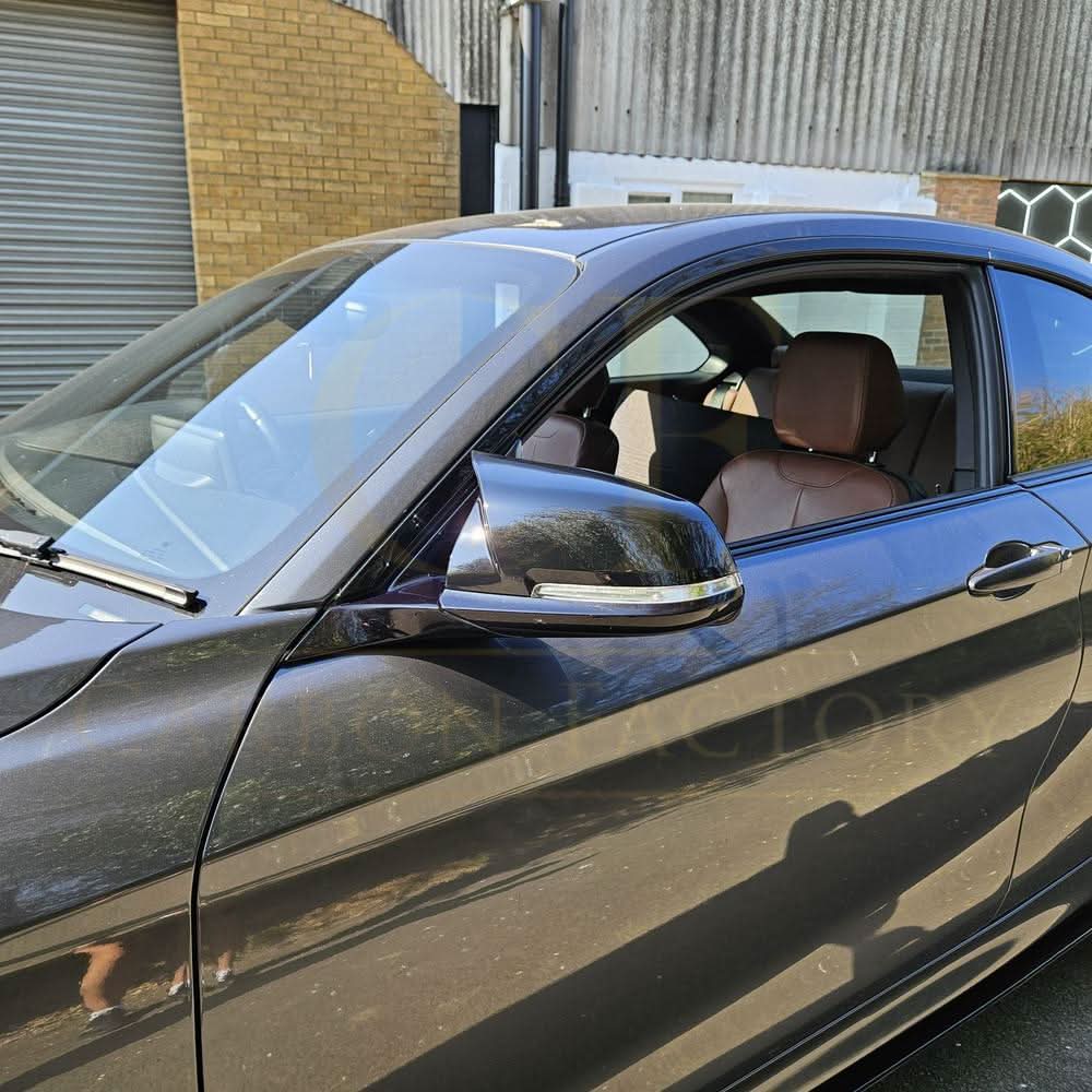 Gloss black M4 style replacement mirror covers for BMW 1, 2, 3, and 4 Series, shown on vehicle mirrors.