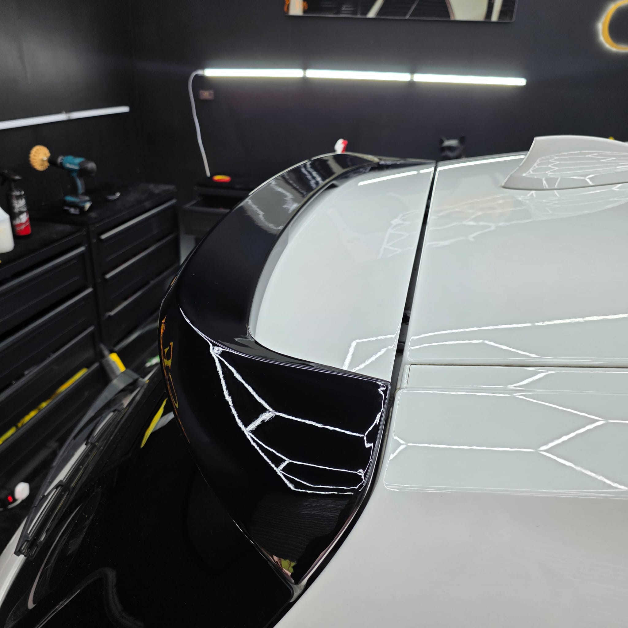 Gloss black roof spoiler for BMW F20 F21 1 Series, stylish aerodynamic accessory visible on the car's rear roof area.