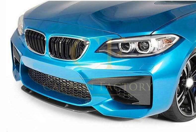 Carbon fibre front bumper covers for BMW F87 M2 2016-2021, exterior trim replacements, showcasing sleek carbon fibre finish.