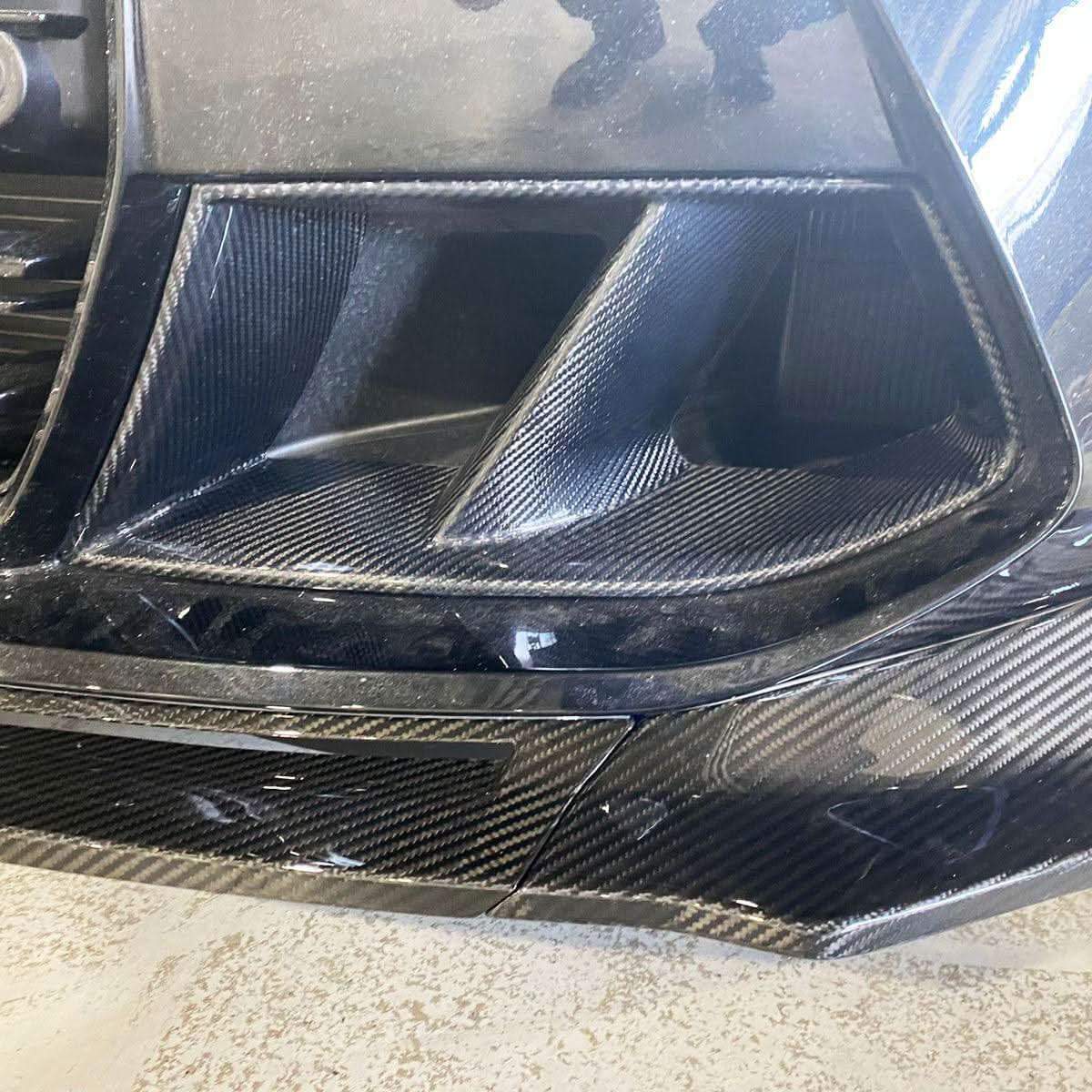 Carbon fibre front bumper inserts for BMW G80 M3, G82 G83 M4 exterior trims, shown installed on the vehicle's front bumper.