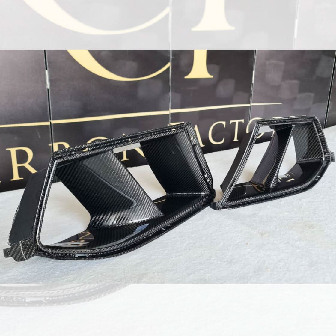 Carbon fibre front bumper inserts for BMW G80 M3, G82 G83 M4 exterior trims, showcasing sleek, high-performance automotive design.