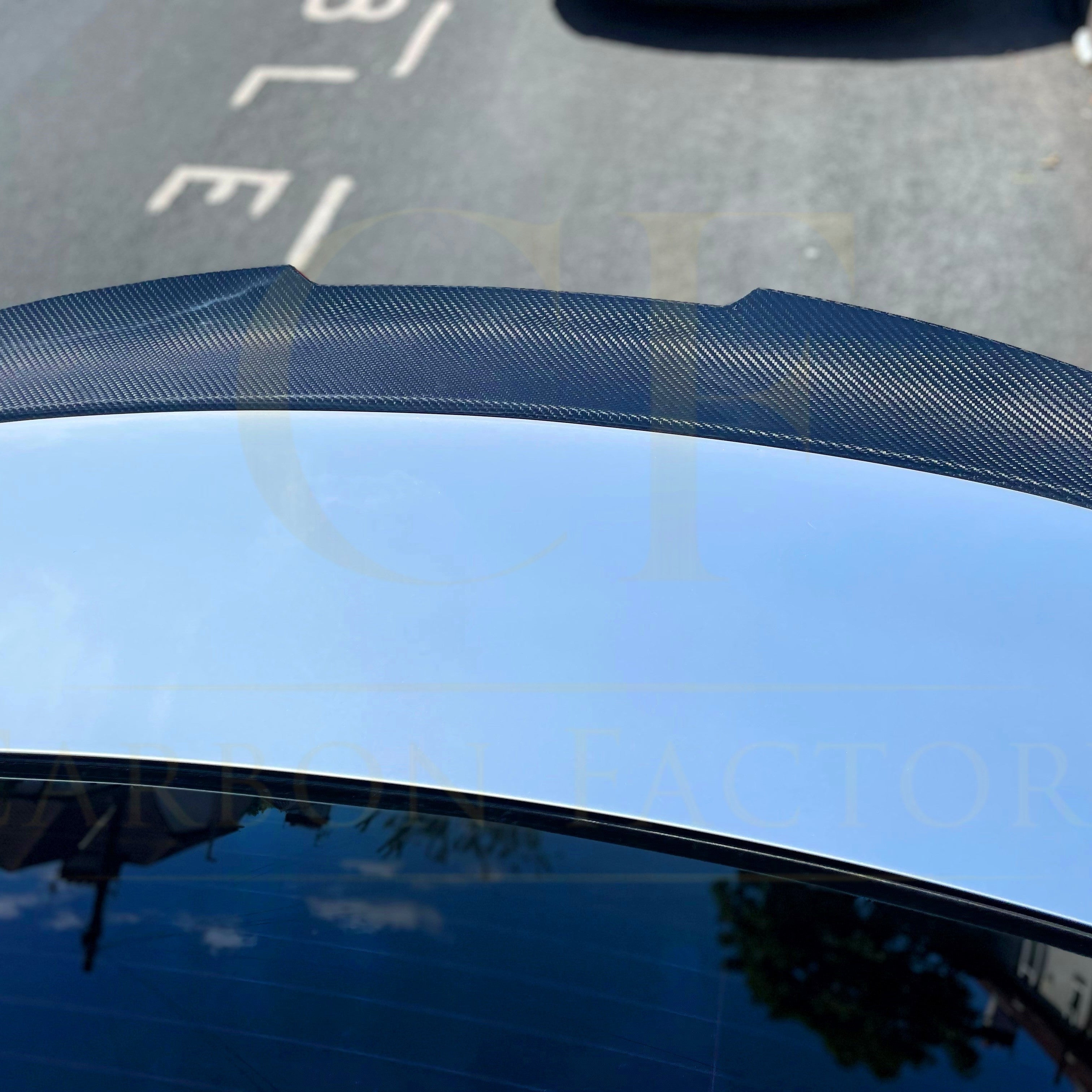 Carbon fibre boot spoiler for BMW 5 Series F10 and M5, featuring aerodynamic design and sleek carbon fibre finish.