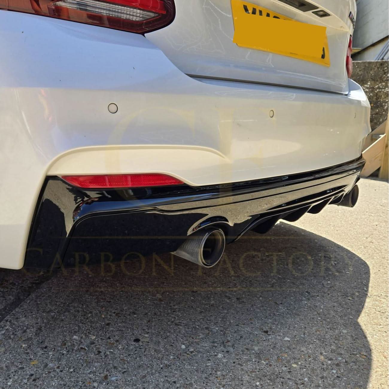 Gloss black rear diffuser with dual exhaust for BMW F22 2 Series M Sport, featuring sleek design and sporty styling.