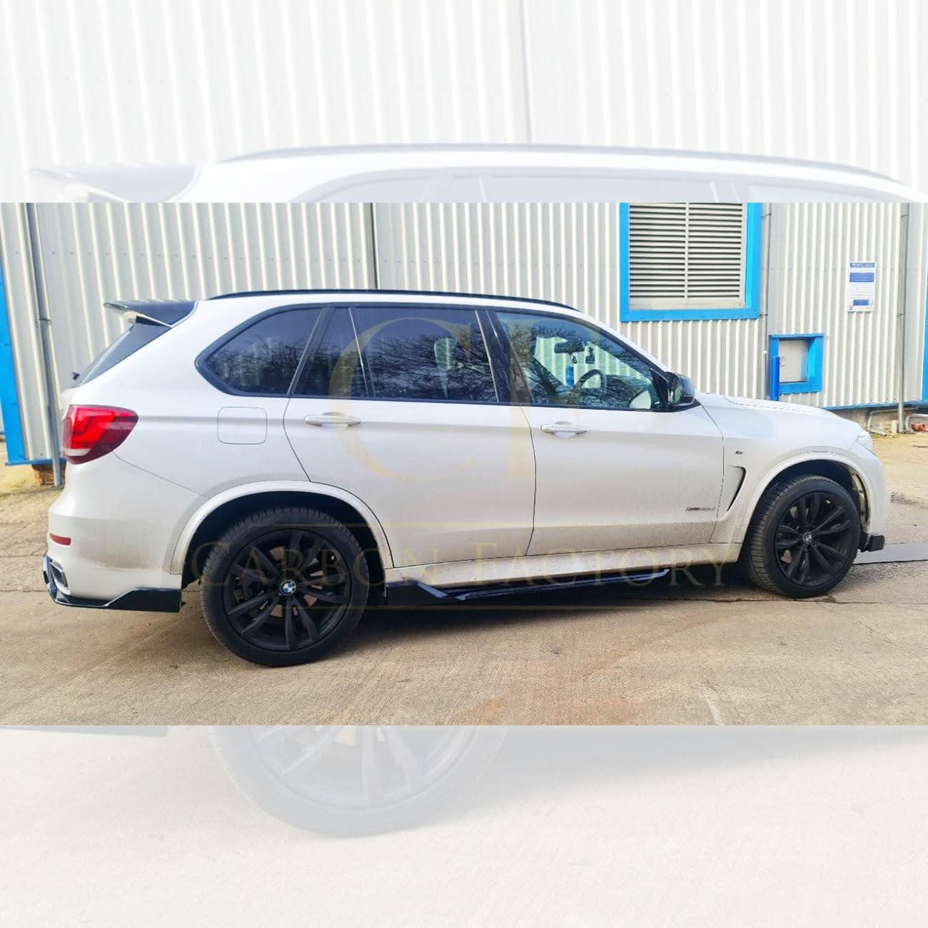 Gloss black BMW F15 X5 body kit including side skirts, splitter, diffuser, and spoiler, featuring a carbon factory style finish.