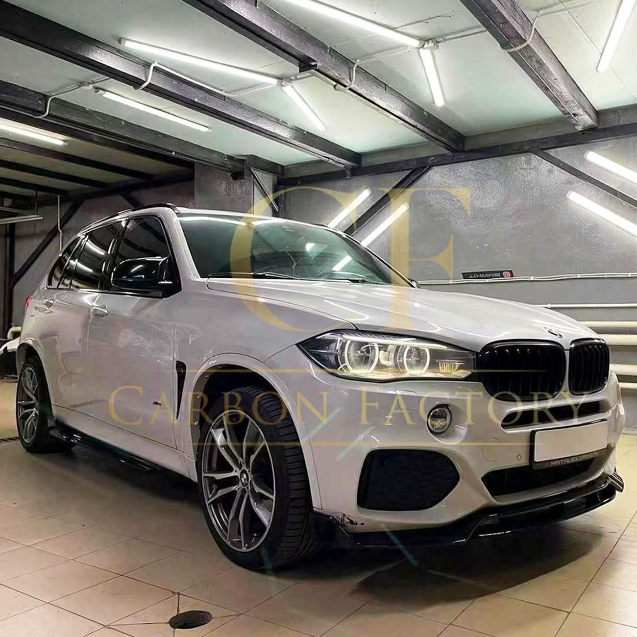 Gloss black carbon fiber body kit for BMW F15 X5, including side skirts, splitter, diffuser, and spoiler, installed on vehicle.