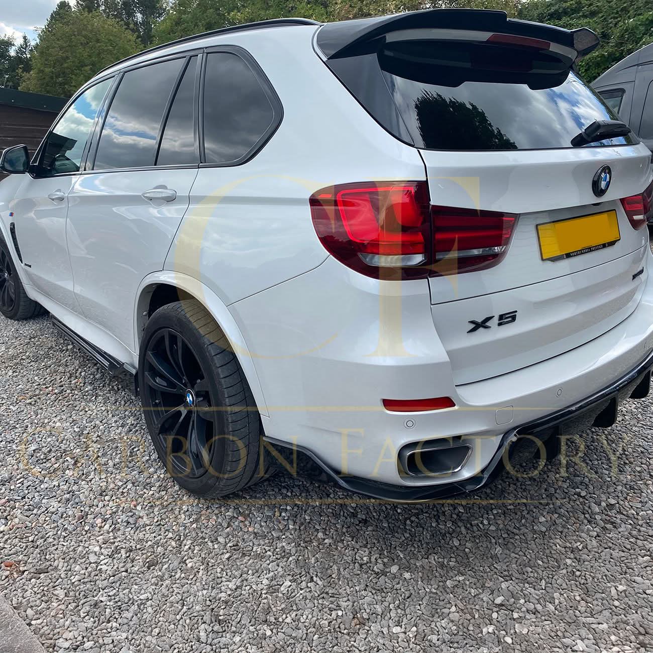 Gloss black BMW F15 X5 body kit with side skirts, splitter, diffuser, and spoiler, featuring a carbon factory style finish.