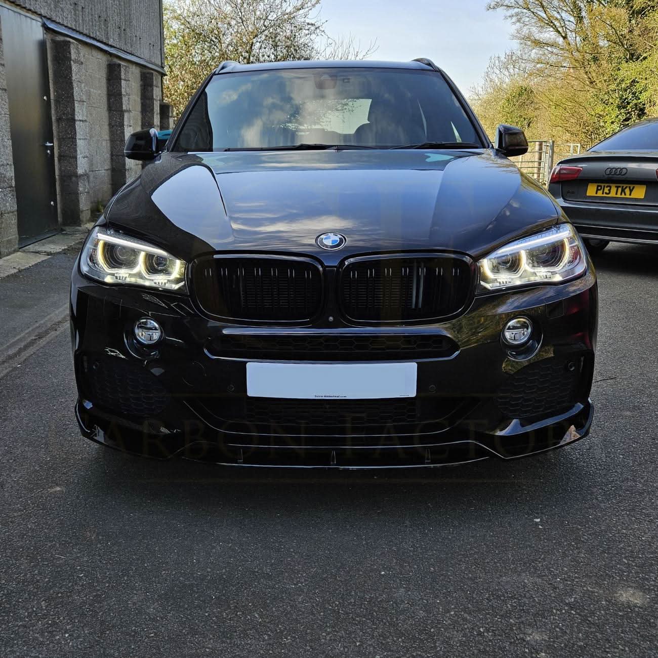 Gloss black BMW F15 X5 body kit with side skirts, splitter, diffuser, and spoiler, featuring a carbon factory style finish.