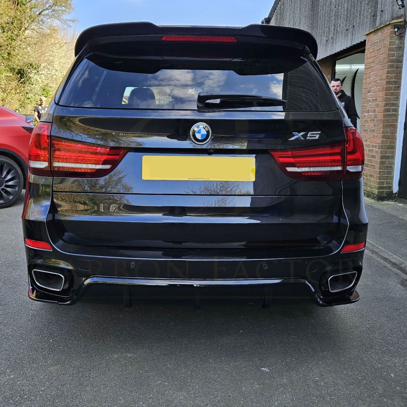 Gloss black BMW F15 X5 body kit including splitter, diffuser, side skirts, and spoiler with carbon factory style finish.