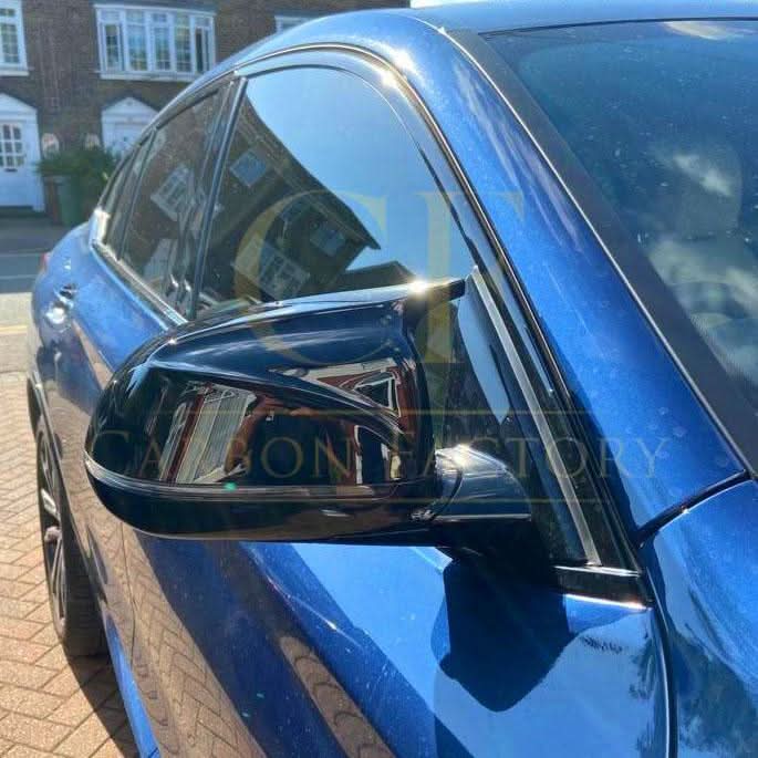 CF Style gloss black BMW mirror covers for G01 X3, G02 X4, G05 X5, G06 X6, G07 X7 models 2018-2025, front view.