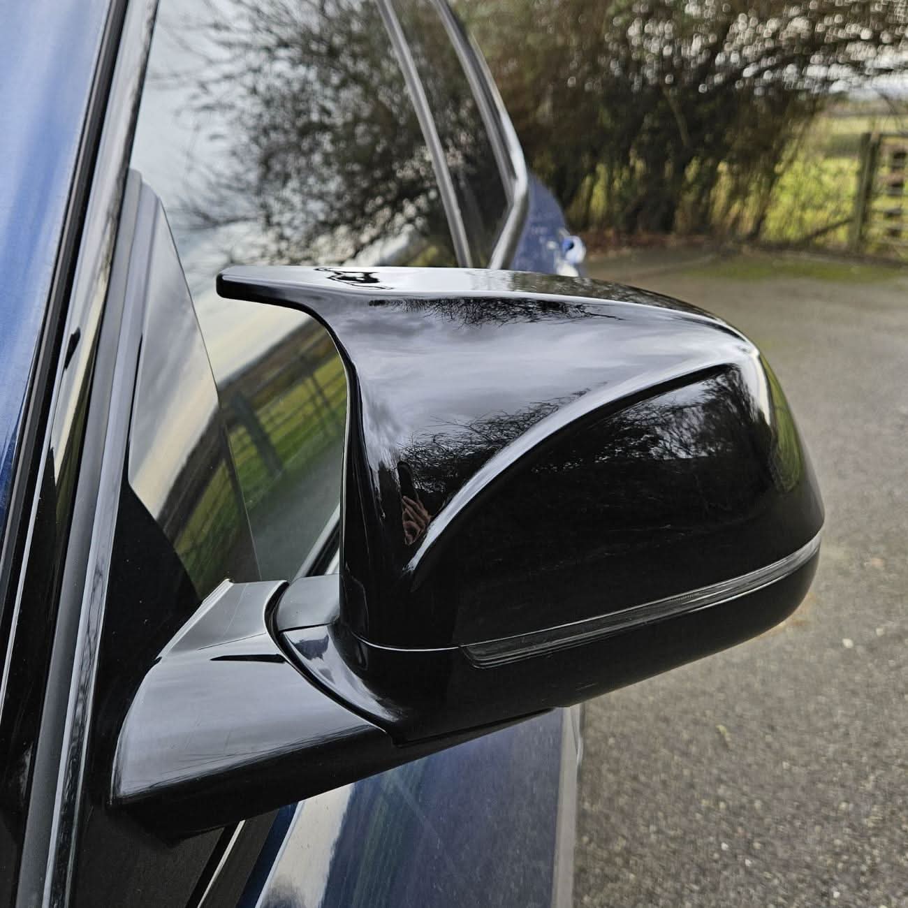 CF Style Gloss Black replacement mirror covers for BMW G01 X3 G02 X4 G05 X5 G06 X6 G07 X7 18-25 series, showing sleek exterior design