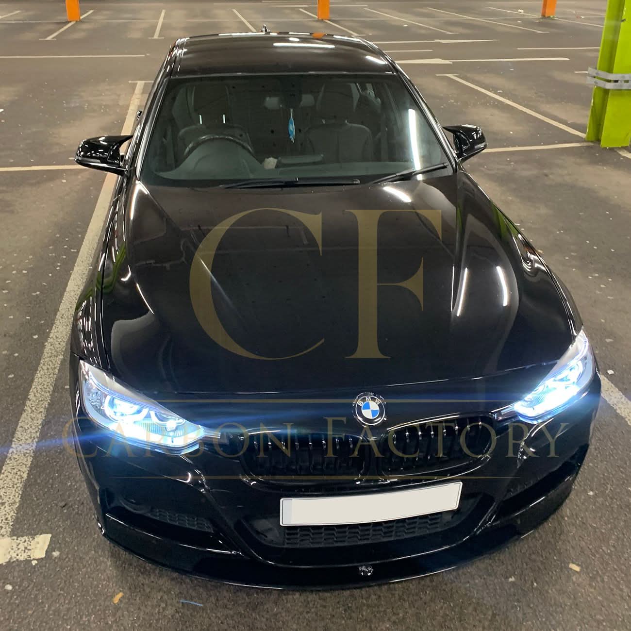 Gloss black M4-style mirror covers for BMW 1, 2, 3, and 4 Series, shown on the side mirrors of the car.