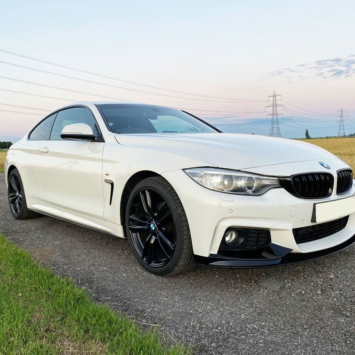 Gloss black OEM-style side skirts for BMW F32 F33 F36 4 Series, 2014-2020, shown installed on the vehicle.