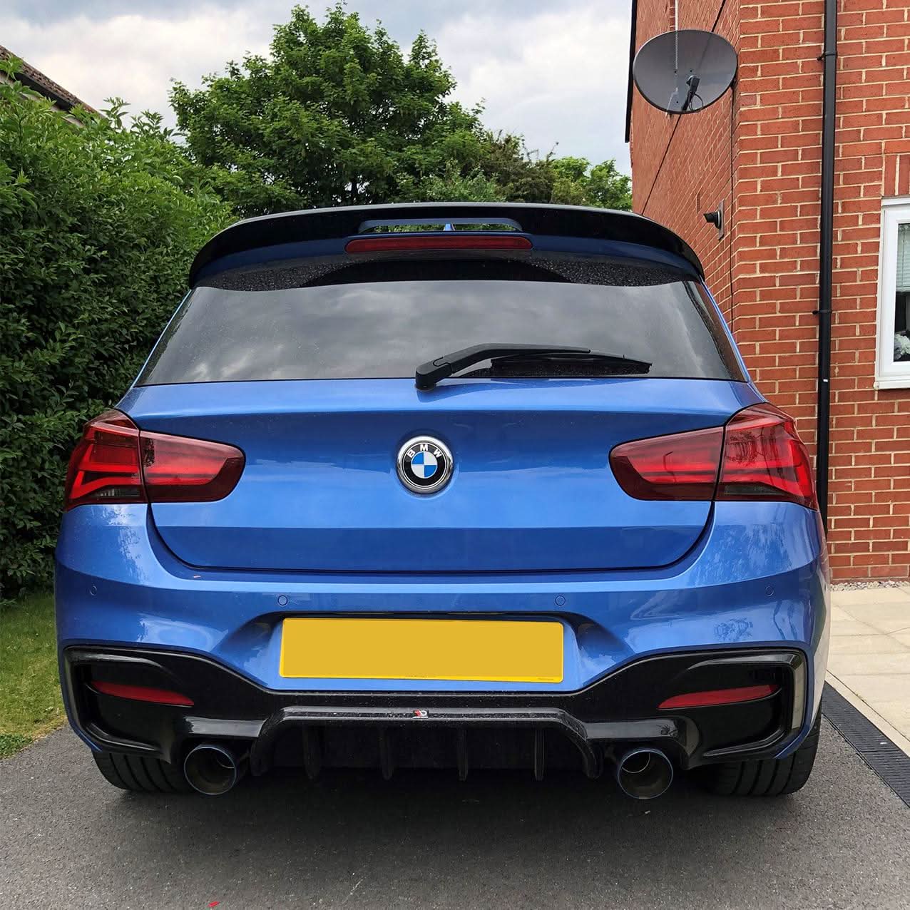 Gloss black roof spoiler for BMW F20 F21 1 Series, MP Style, installed on the car's roof for a sleek sporty look.