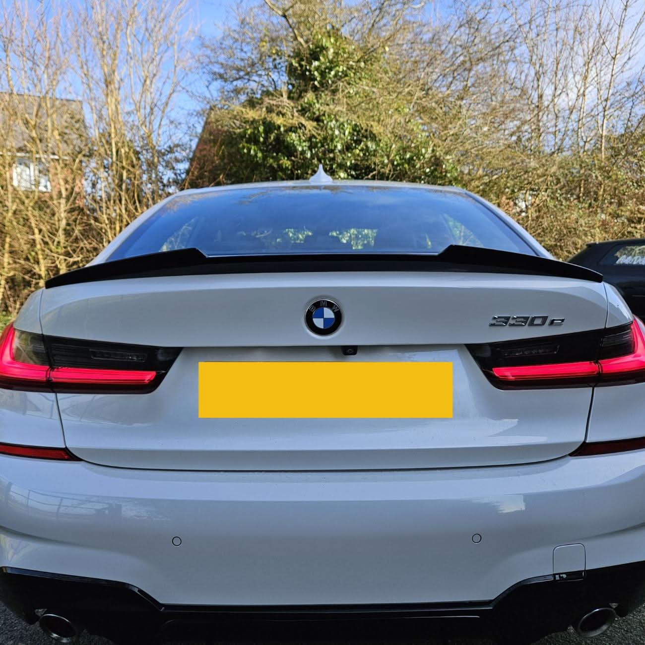 Gloss black V-style boot spoiler for BMW G20 3 Series G80 M3, showing its sleek aerodynamic design on the trunk lid.