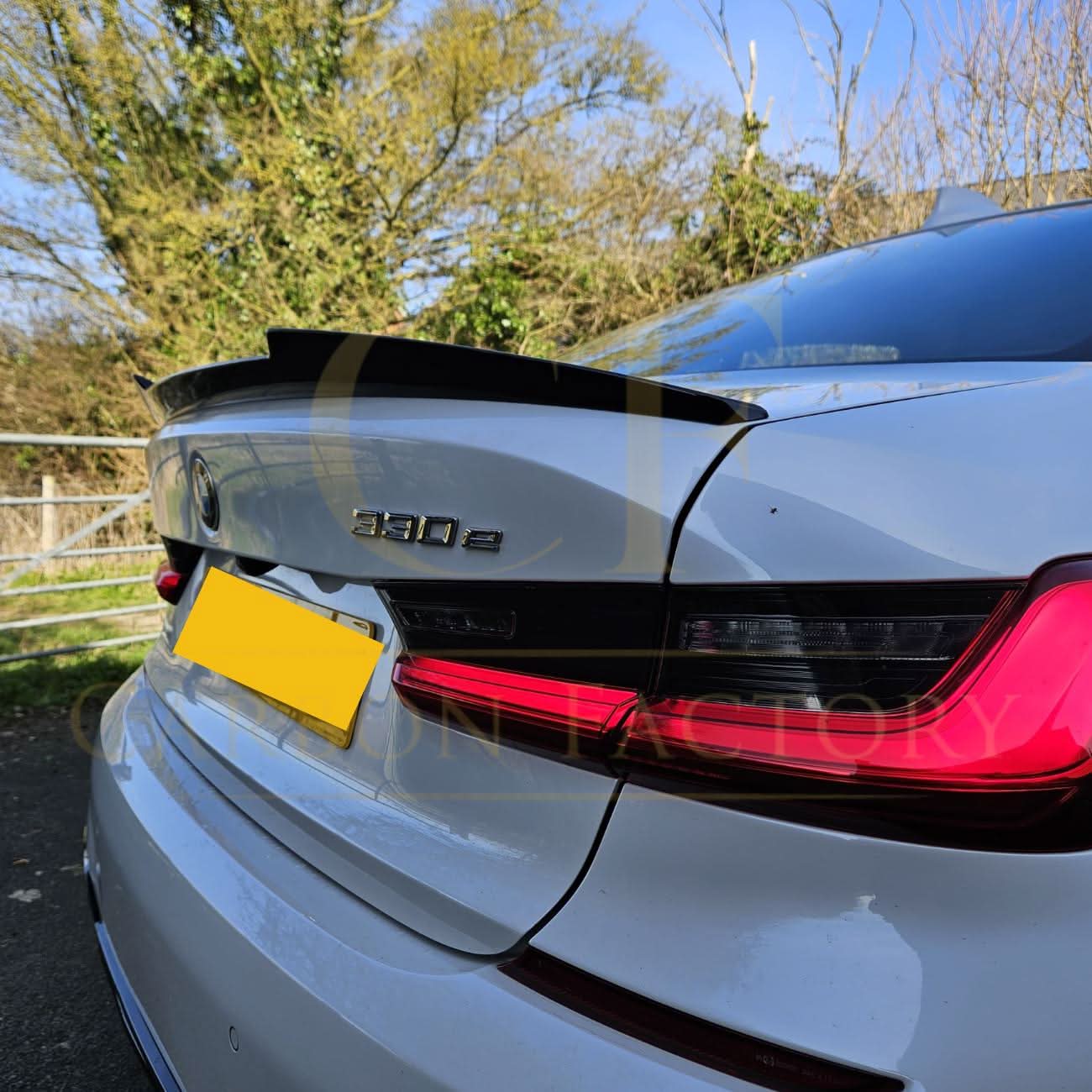 V Style gloss black boot spoiler for BMW G20 3 Series G80 M3, showing sleek aerodynamic design on the vehicle's rear.