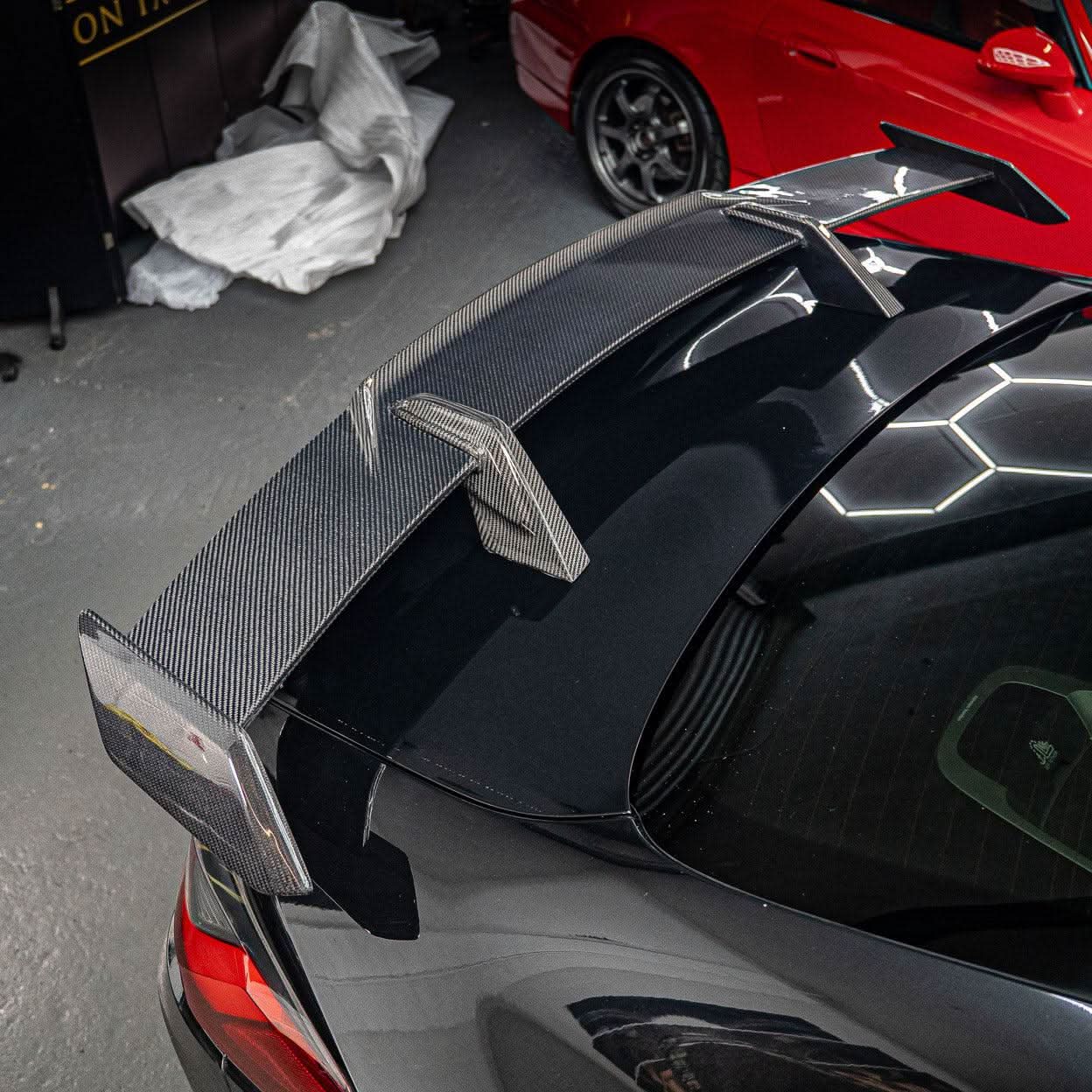 Pre-Preg carbon fiber boot spoiler for BMW G80 M3 and G82 M4, featuring sleek, aerodynamic design for sporty performance.