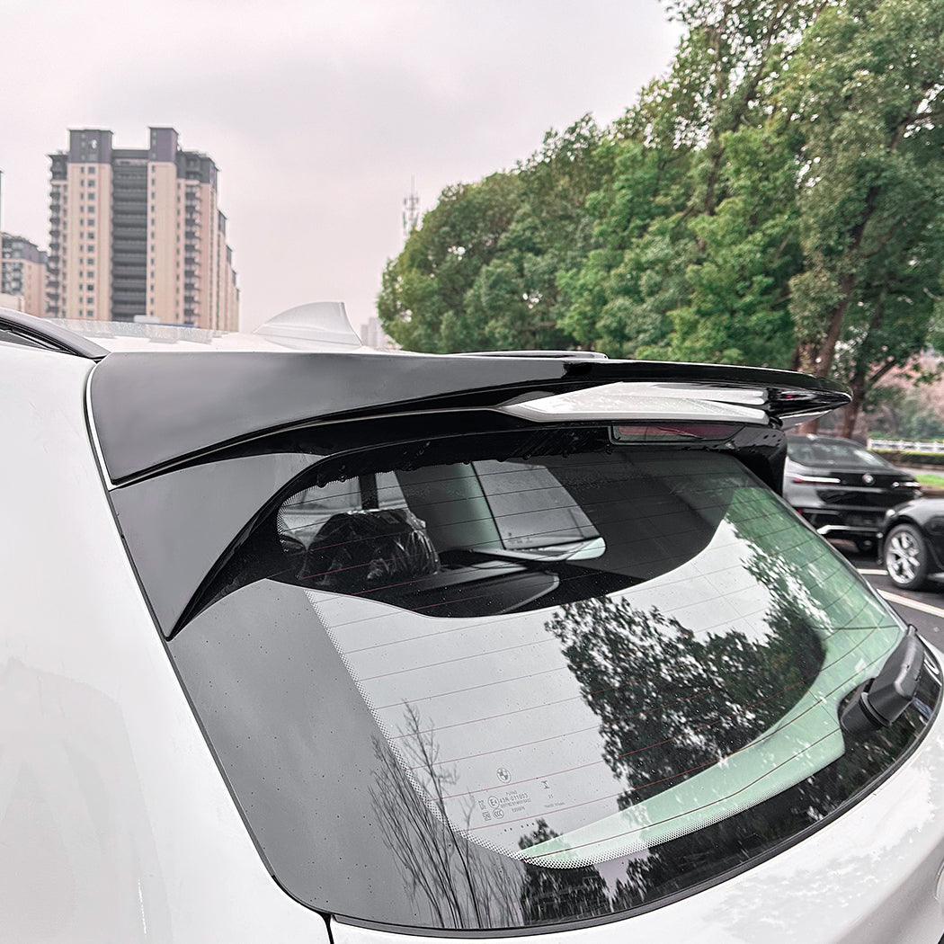 Gloss black roof spoiler for BMW G01 X3 and iX3, showcasing a sleek aerodynamic design on a black vehicle roof.