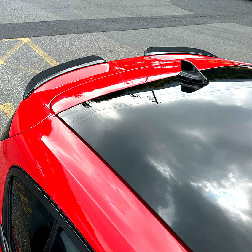 Gloss black roof spoiler for Ford Focus ST C519 MK4 (2019-2022), aerodynamic car accessory, mounted on vehicle roof.