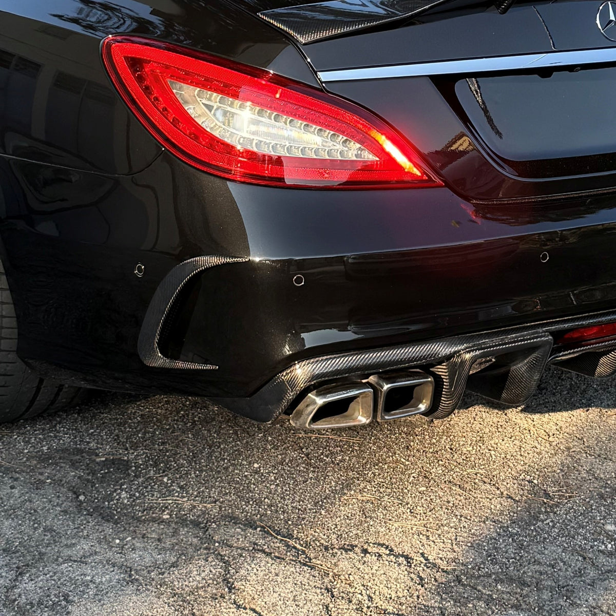 Carbon Fibre rear bumper trim for Mercedes C218 CLS 2015-2018 exterior accessories, showcasing sleek, high-quality carbon fiber finish.