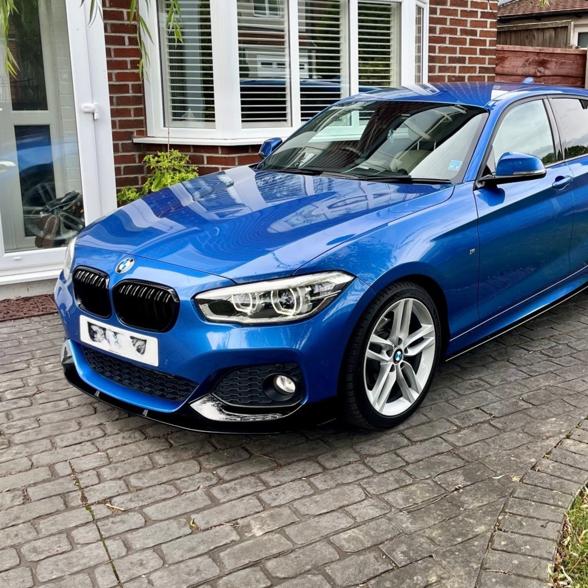 Gloss Black front splitter for BMW F20 F21 1 Series LCI 2015-2019, designed to enhance vehicle sporty appearance.