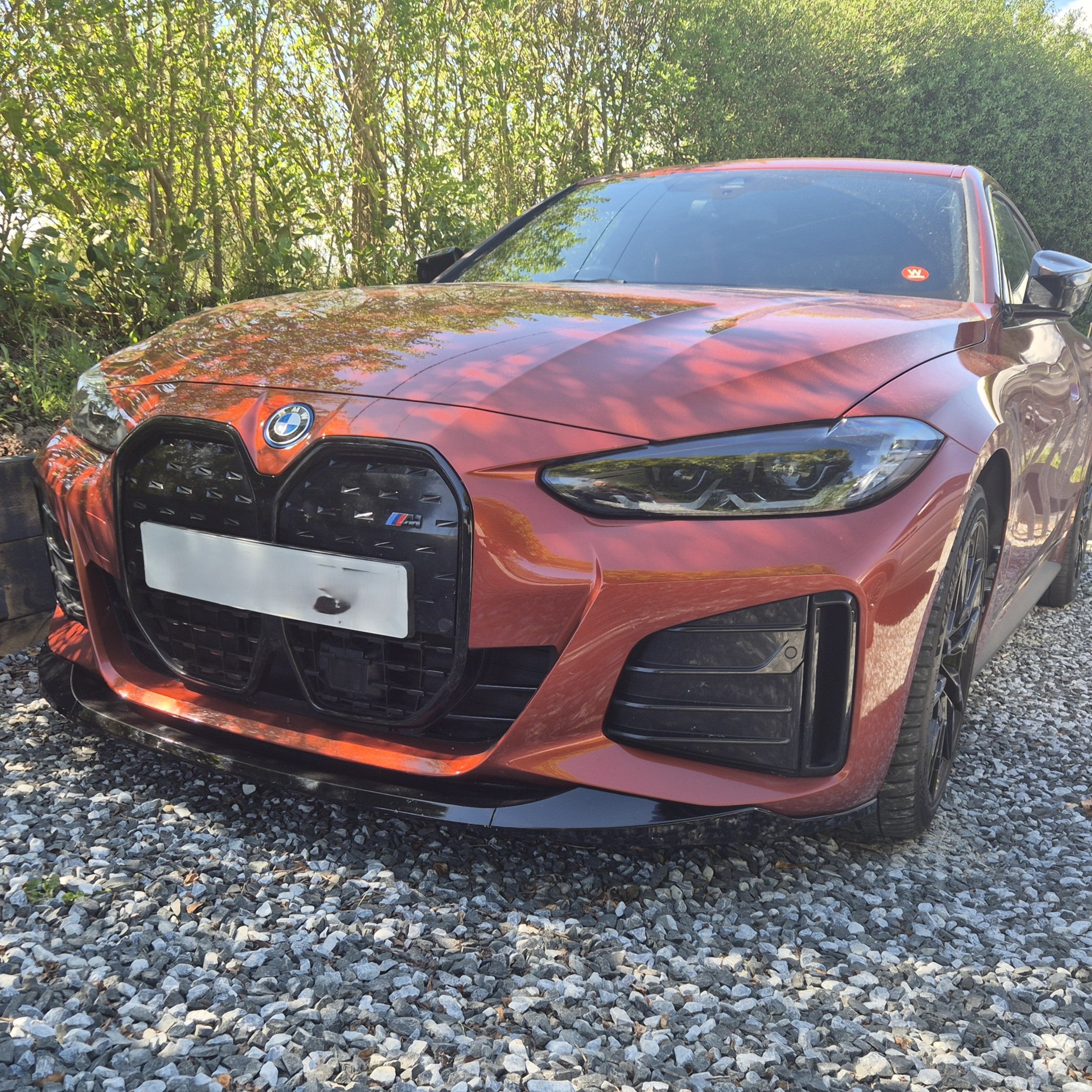 Gloss Black front splitter for BMW 4 Series G26 Gran Coupe and i4, enhances sporty appearance and aerodynamics.