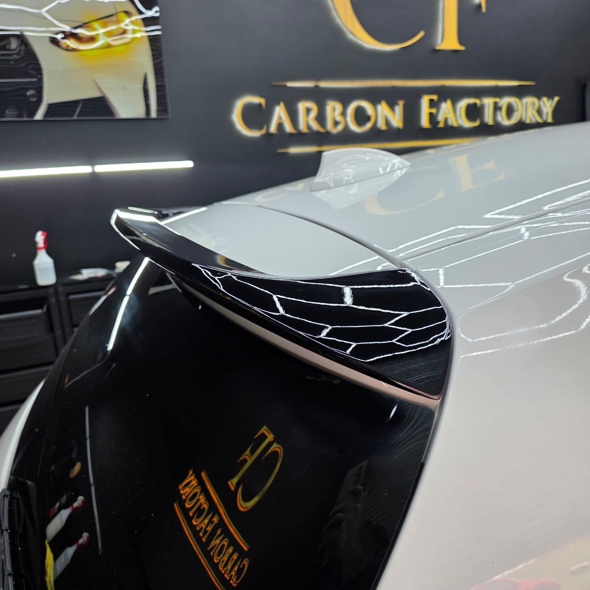 Gloss black roof spoiler for BMW F20 F21 1 Series, sleek and aerodynamic, shown installed on the car's roof.