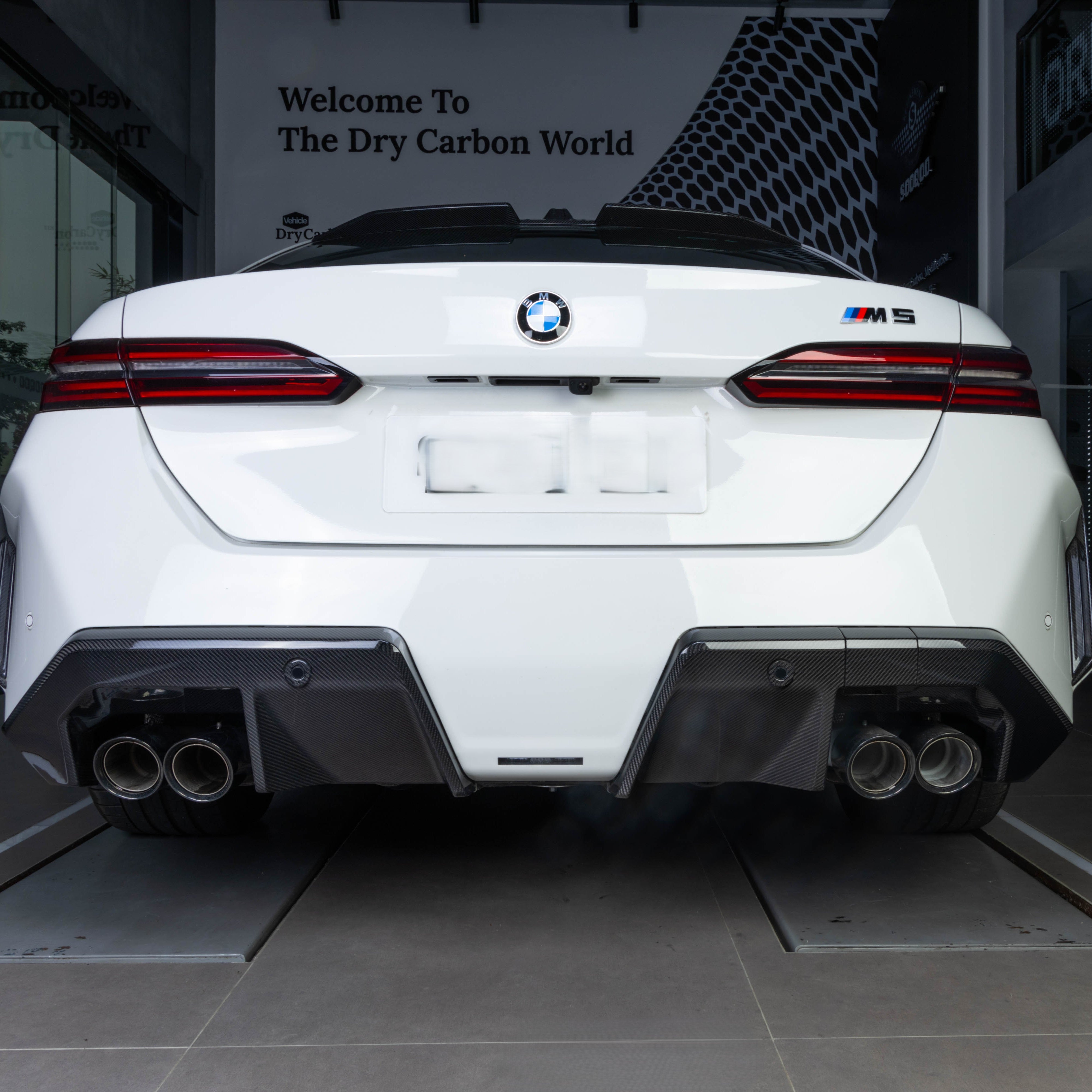 OEM Style Pre-Preg Carbon Fibre rear diffuser for BMW G90 G99 M5 2025+ showing sleek carbon fiber design and aerodynamic styling.