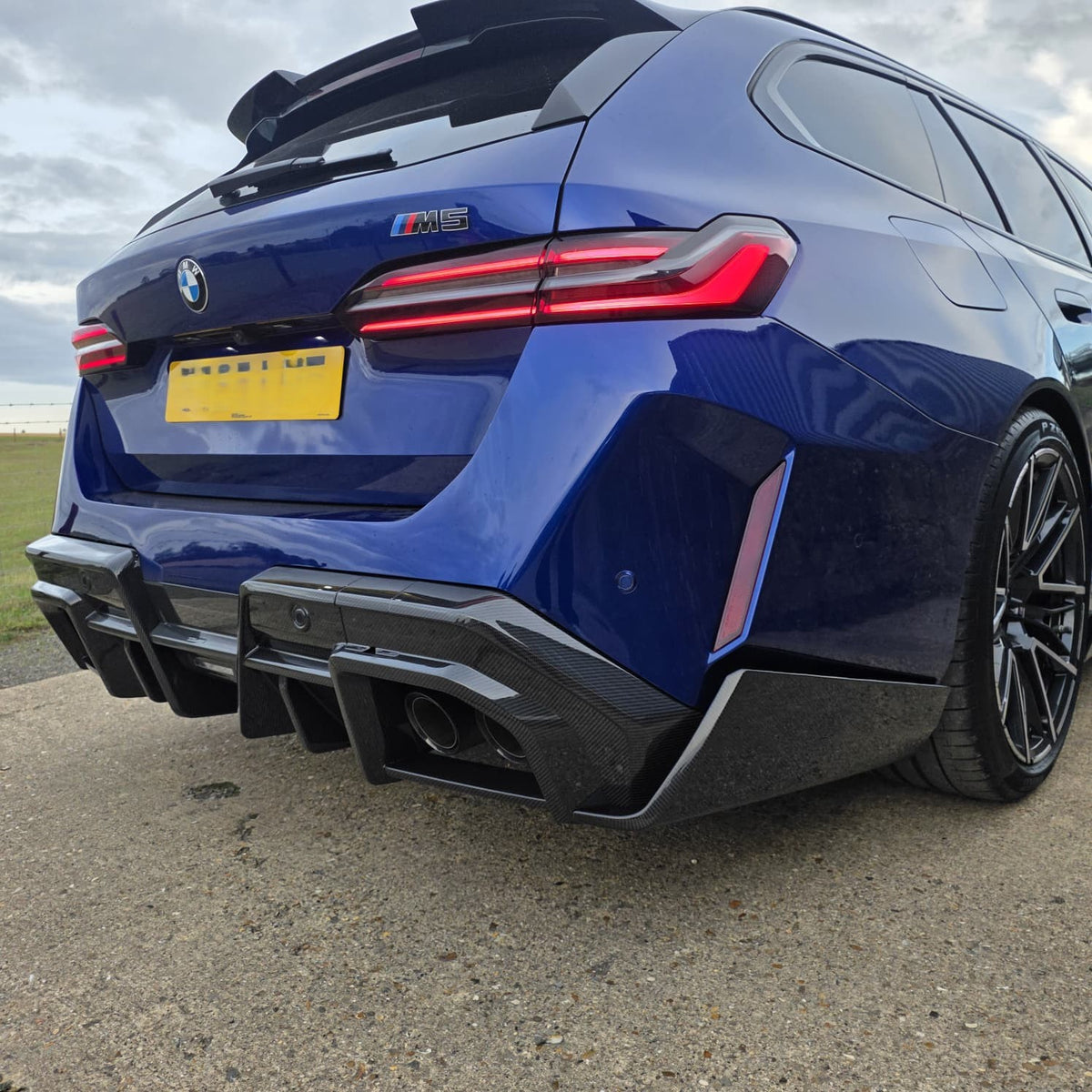 Pre-Preg Carbon fiber rear diffuser for BMW G90 G99 M5 2025+, showcasing sleek aerodynamic design and high-quality material.