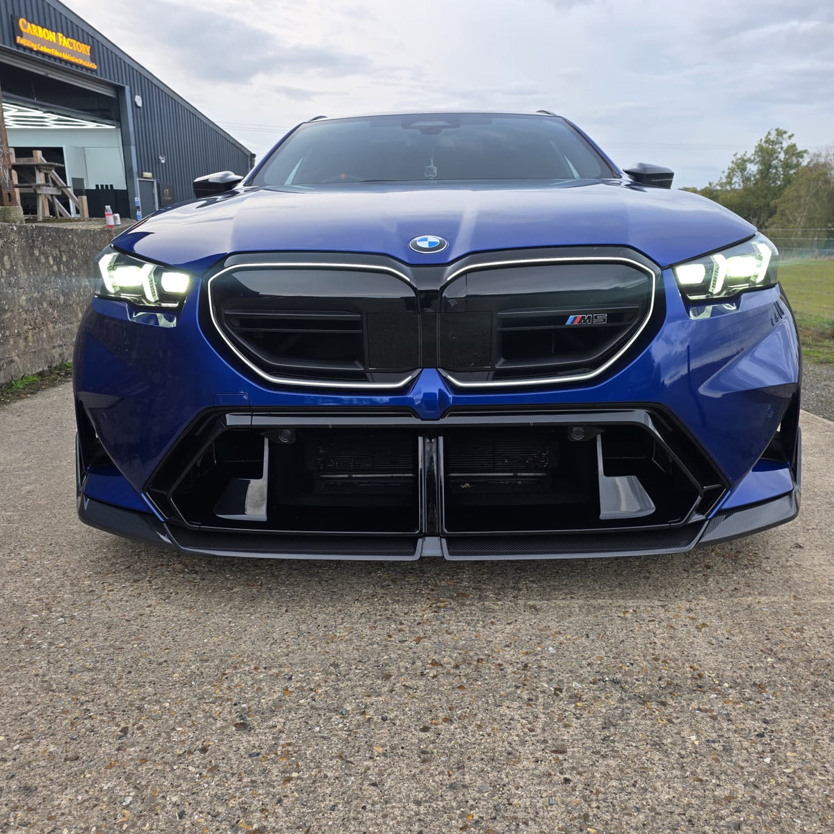 Pre-Preg Carbon fiber front splitter for BMW G90 G99 M5 2025-present, showcasing sleek aerodynamic design and premium material.