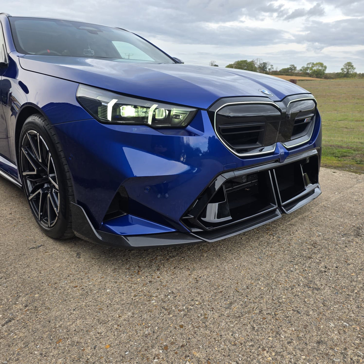 Pre-Preg Carbon fibre front splitter for BMW G90 G99 M5 2025 model, showcasing sleek aerodynamic design and high-quality material