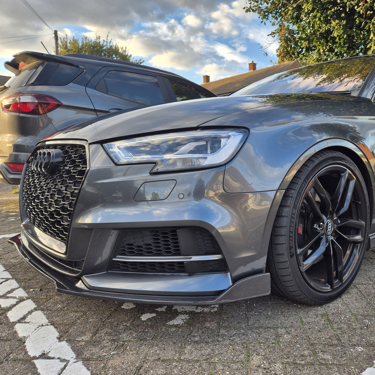 Carbon Fibre front splitter for Audi A3 Saloon S Line and S3 models, enhances aerodynamics and sporty appearance.