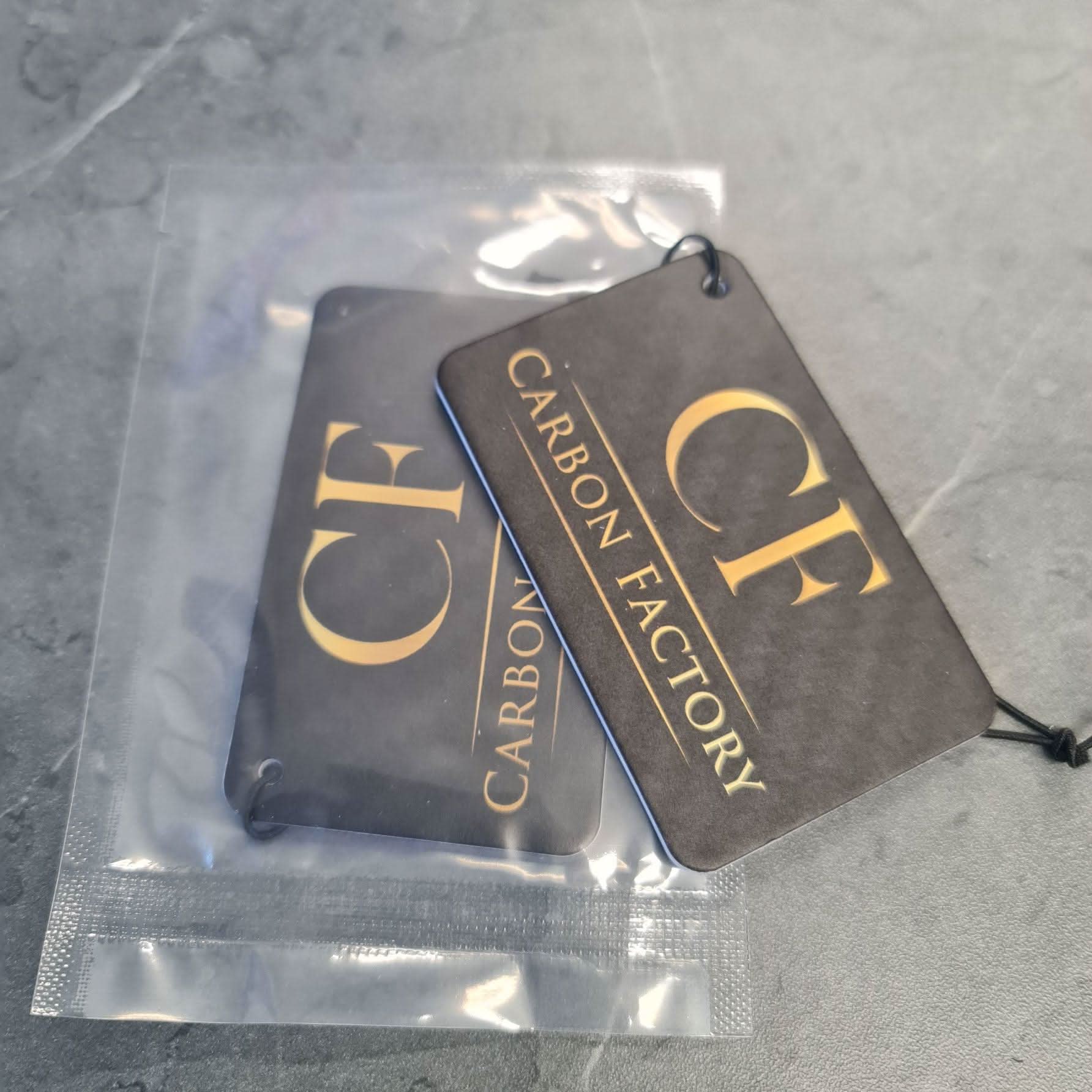 Carbon Factory air freshener accessory featuring sleek design and branding, designed to improve car or room scent.