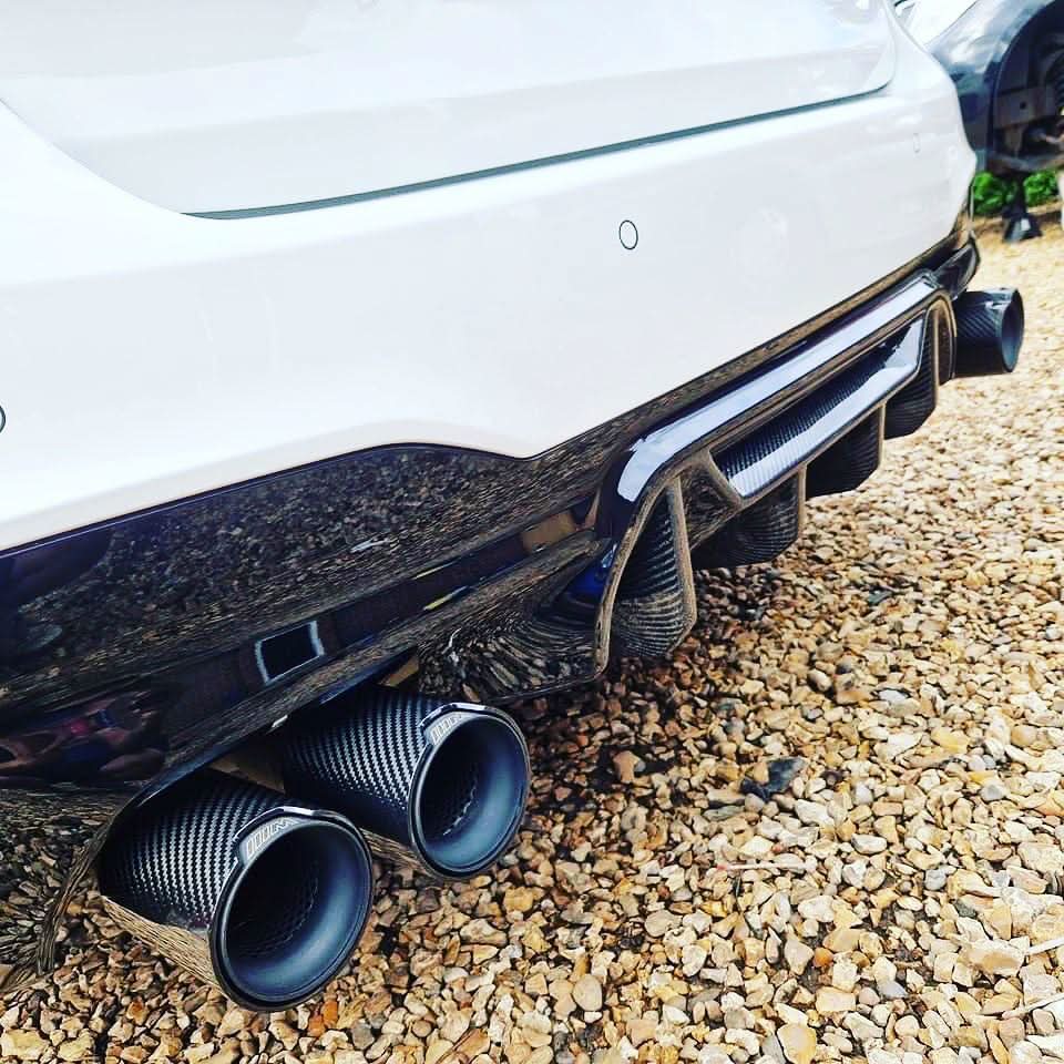 Carbon fibre rear diffuser for BMW F90 M5 (2017-2024) by MP Style, showcasing sleek aerodynamic design.