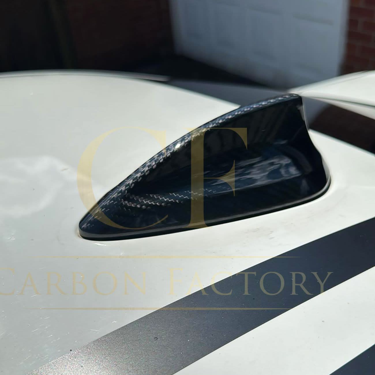 Pre-preg carbon fiber shark fin antenna cover on a BMW F22, F30, F32, M2, M3, M4 exterior trim, sleek and aerodynamic design.