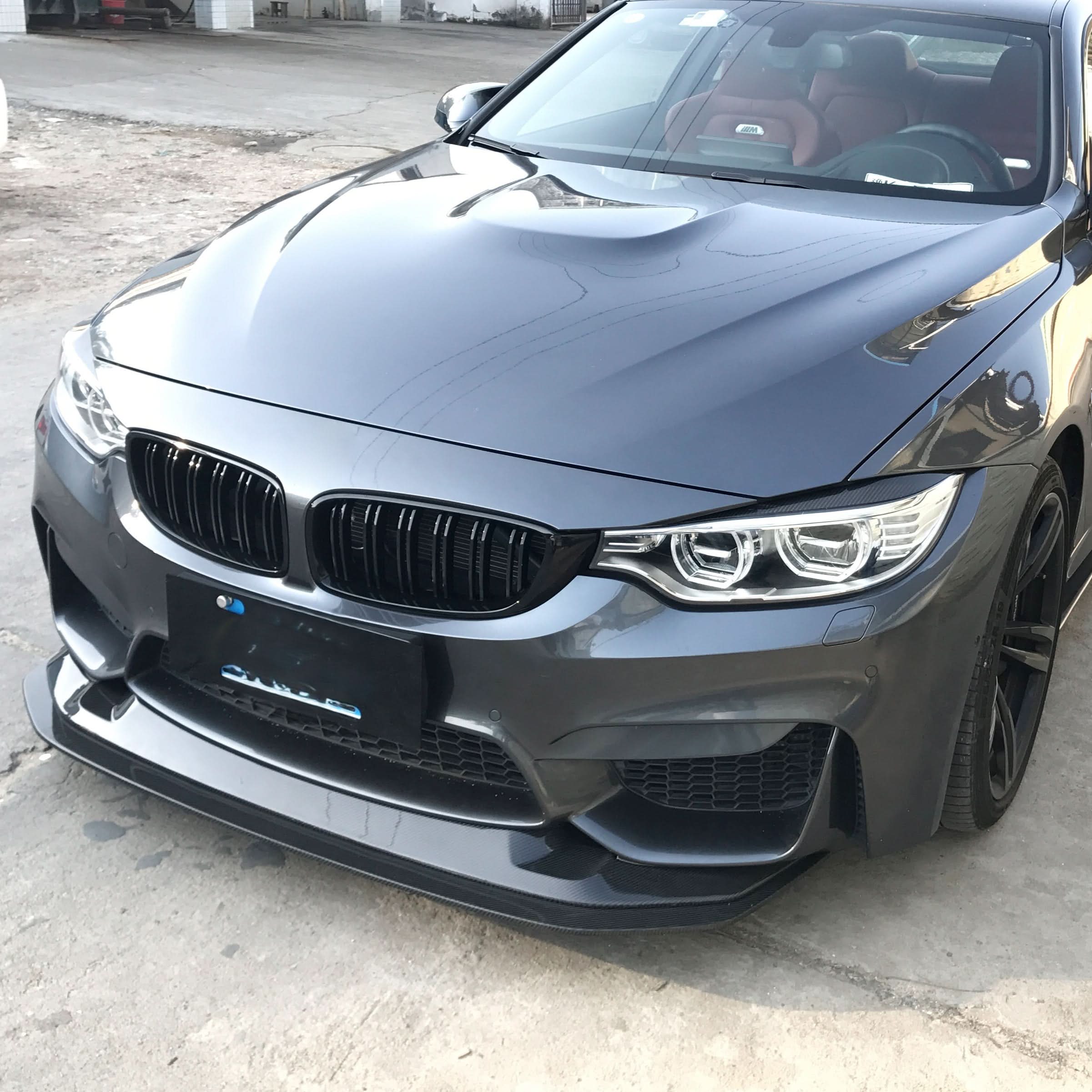 Carbon fibre GTS style front splitter for BMW F80 M3, F82 F83 M4 models from 2014 to 2020, showcasing its sleek aerodynamic design.