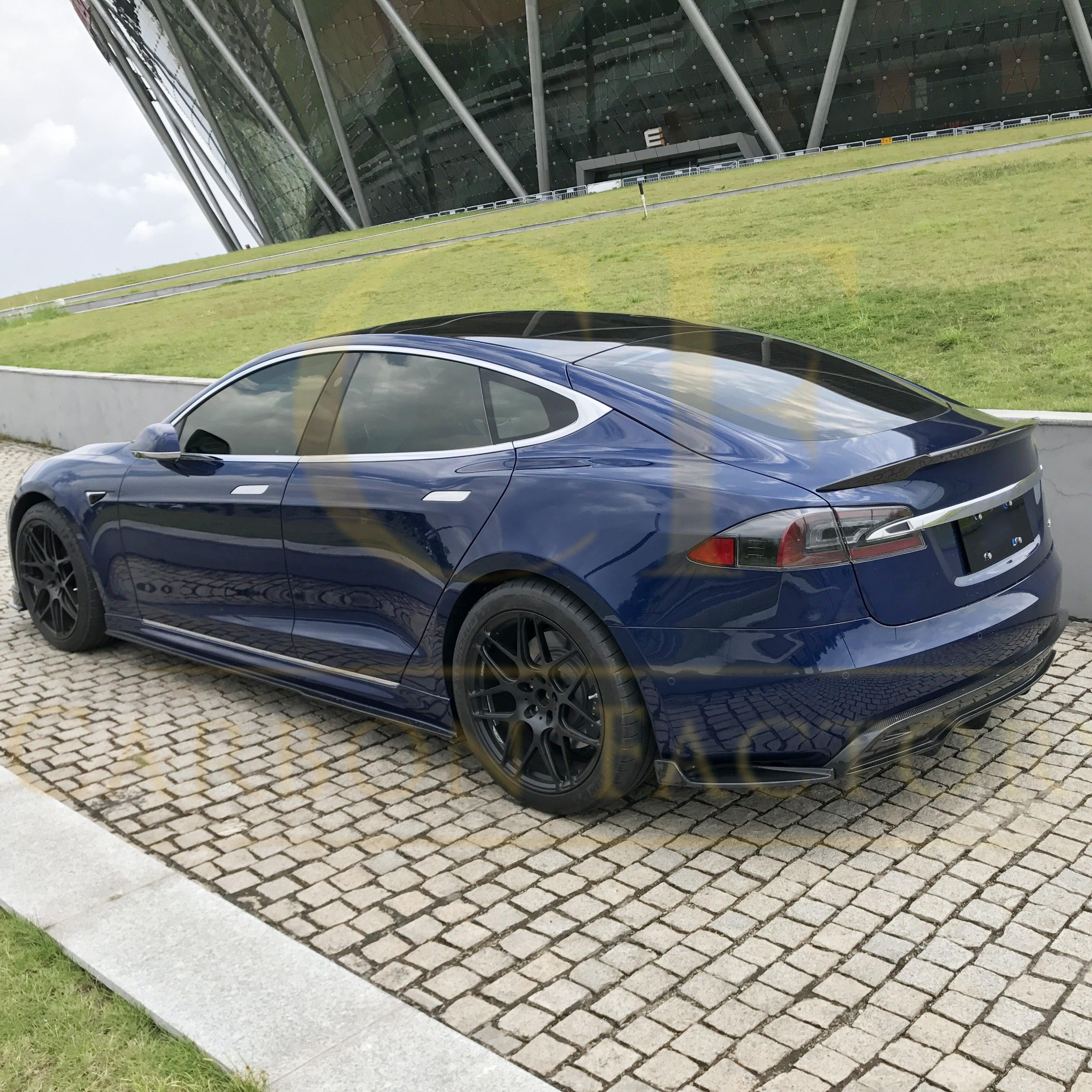 C-style carbon fibre boot spoiler for Tesla Model S 2013-2022, sleek aerodynamic accessory with a textured carbon fibre finish