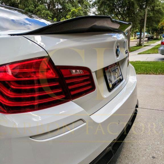 Carbon fibre boot spoiler for BMW 5 Series F10 and M5 models, featuring sleek carbon fibre design and aerodynamic styling.