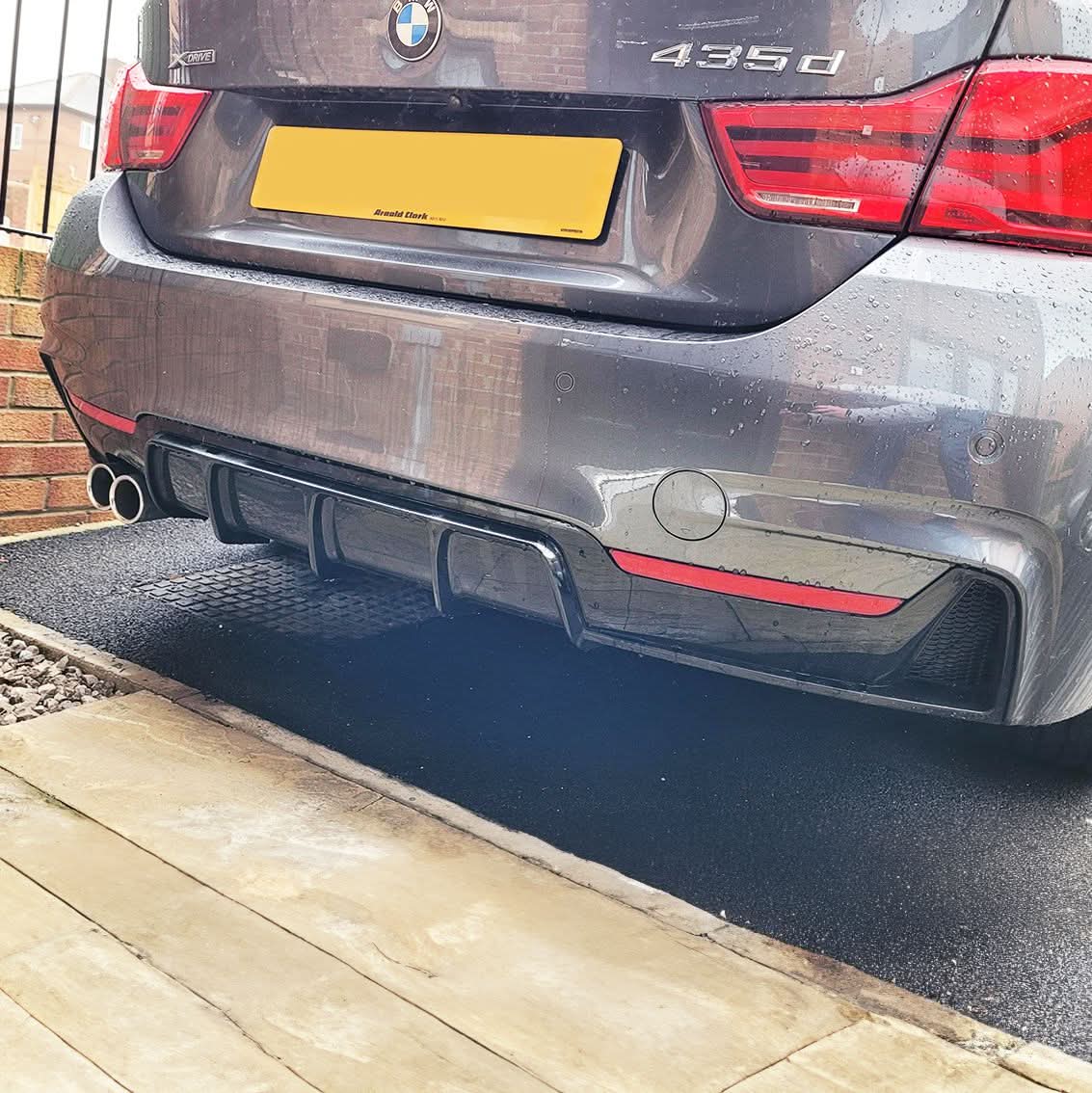 Gloss black rear diffuser with twin exhaust outlets for BMW F32, F33, and F36 4 Series models from 2014 to 2020.