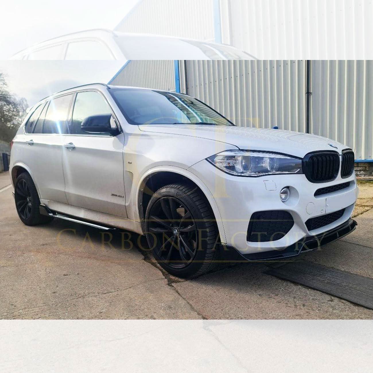 Gloss black BMW F15 X5 body kit with side skirts, splitter, diffuser, and spoiler, showcasing a sleek, aerodynamic design.
