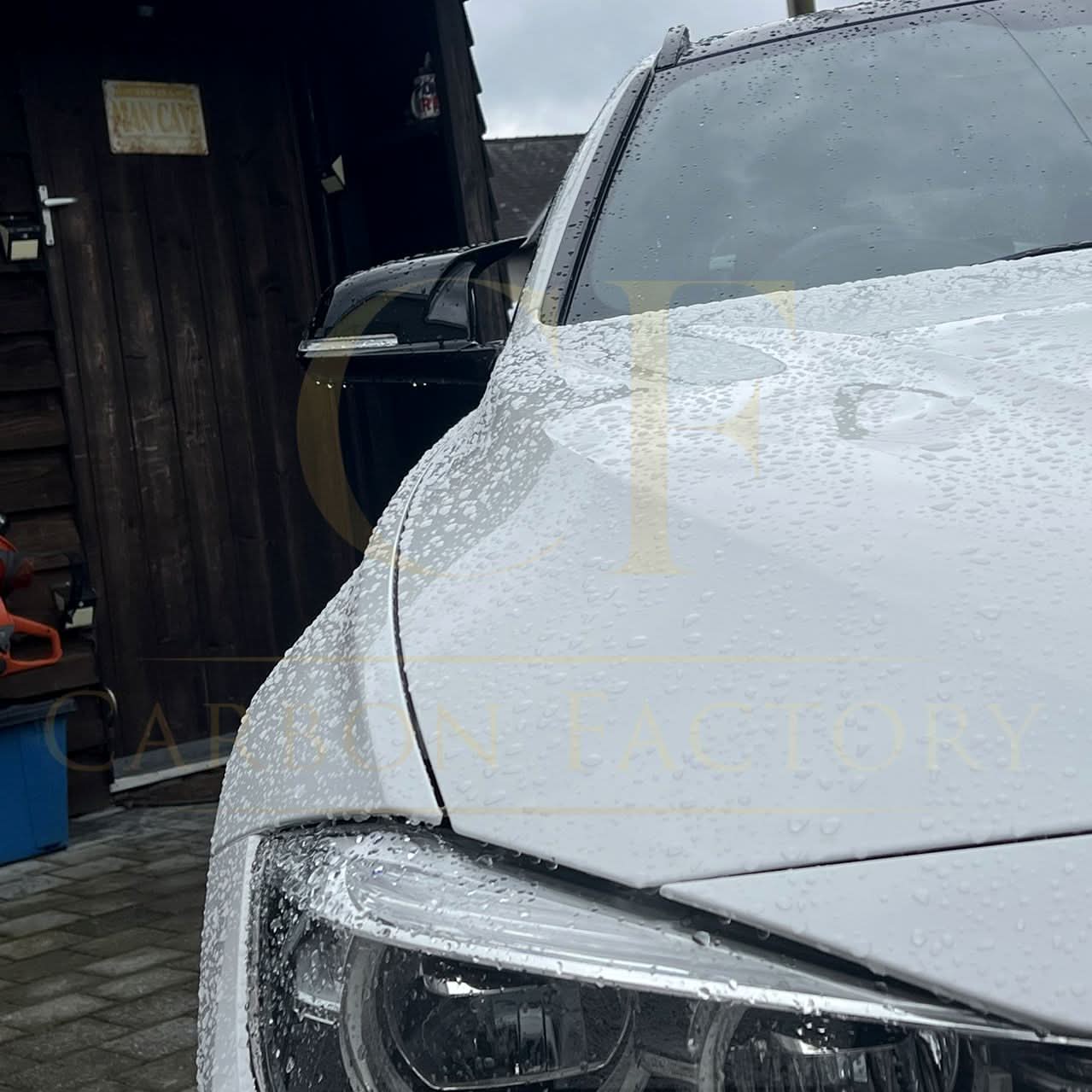 Gloss black M4-style replacement mirror covers for BMW 1, 2, 3, and 4 Series, shown on car mirrors.
