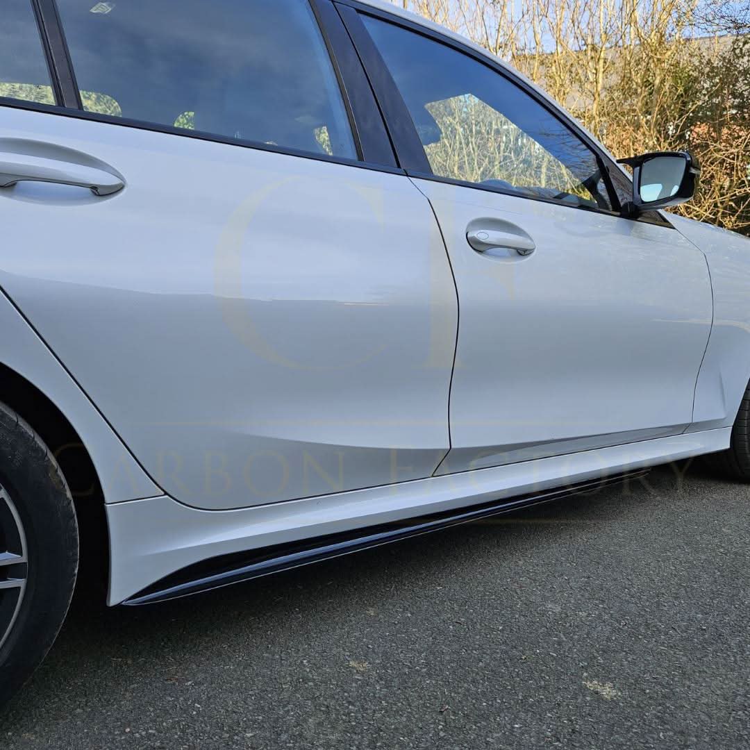 Gloss black side skirts for BMW 3 Series G20 G21, MP Style, installed on the vehicle, enhancing sporty appearance.