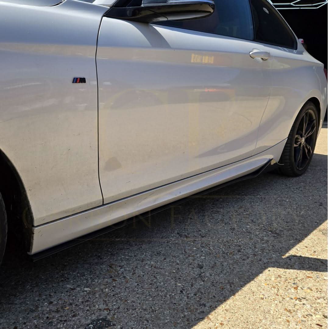 Gloss black side skirts for BMW F22 2 Series and F87 M2, MTC Style, shown on car with detailed close-up.