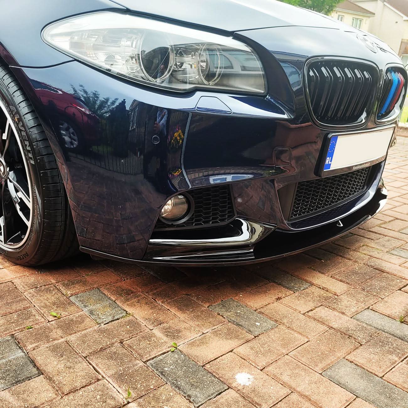 Gloss black front splitter for BMW F10 F11 5 Series, enhancing sporty look with a sleek, aerodynamic design.
