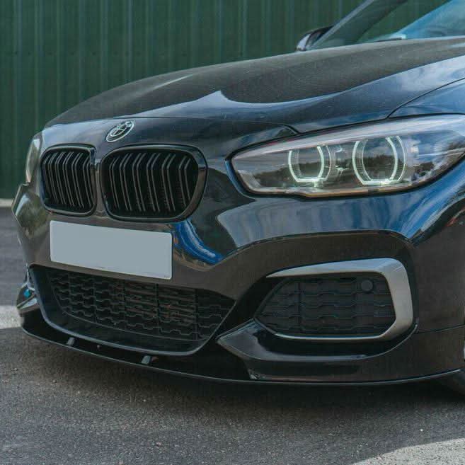Gloss black MP Style front splitter for BMW F20 F21 1 Series LCI 2015-2019, showing the sleek aerodynamic design on the vehicle.